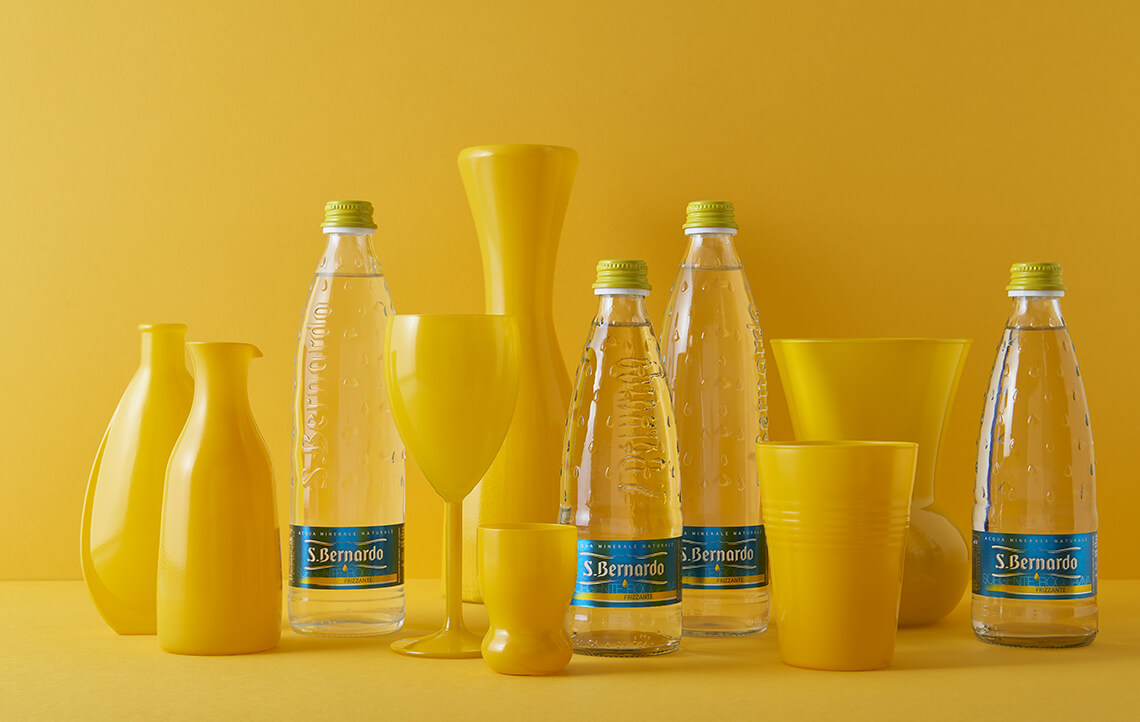 San Bernardo water bottles arranged with yellow serving pieces
